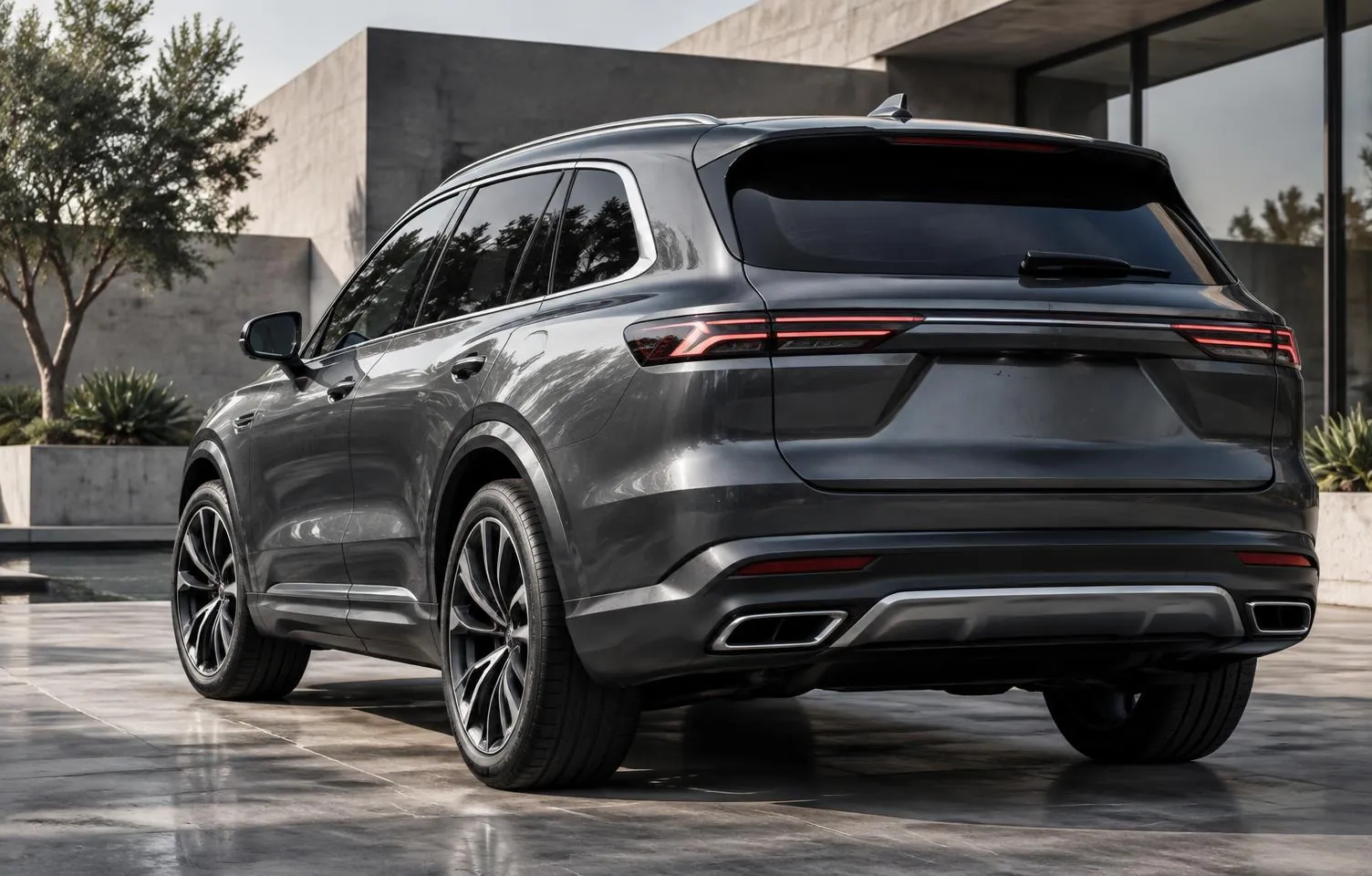 Rear view of a dark silver luxury SUV in a modern courtyard